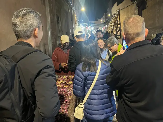 Guests gathered at a street stall in a Medina alley at night