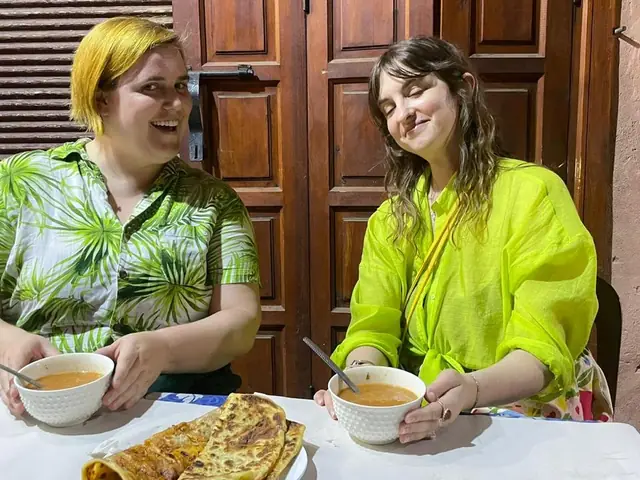 Two guests with bowls of soup and stuffed msemen
