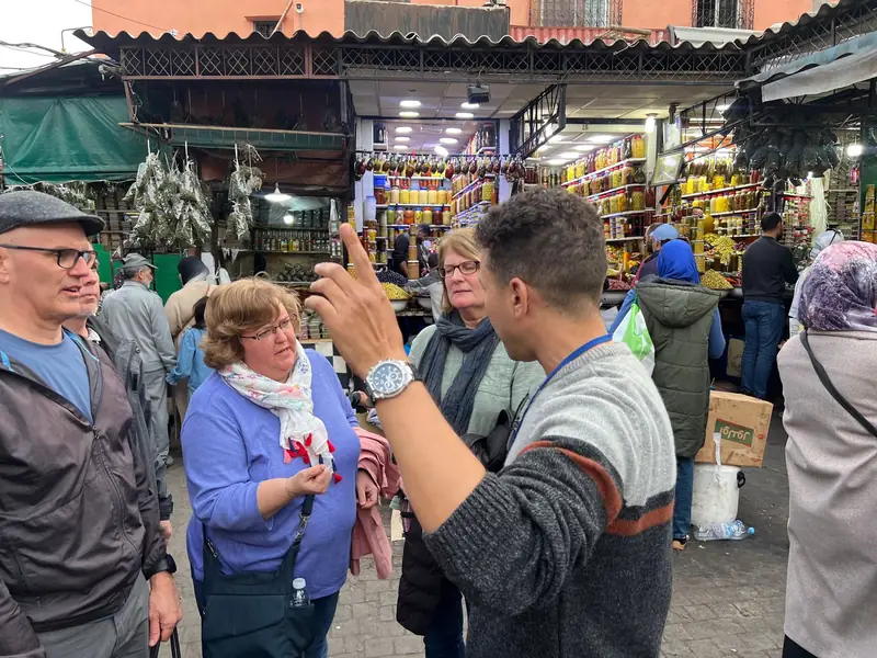 Guide talking guests through the olive market