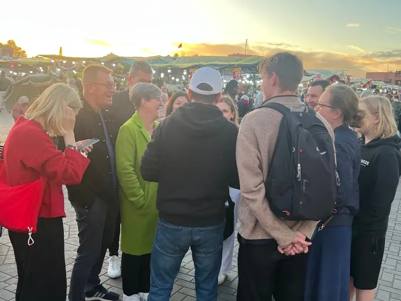Group gathering at sunset in the square